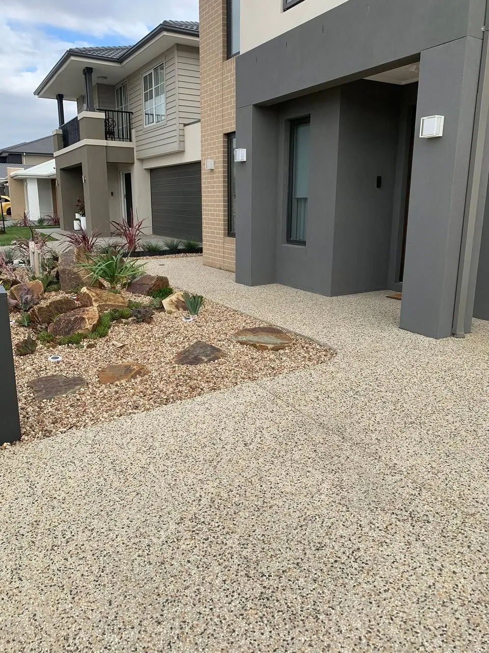 Exposed aggregate driveway on a modern estate home